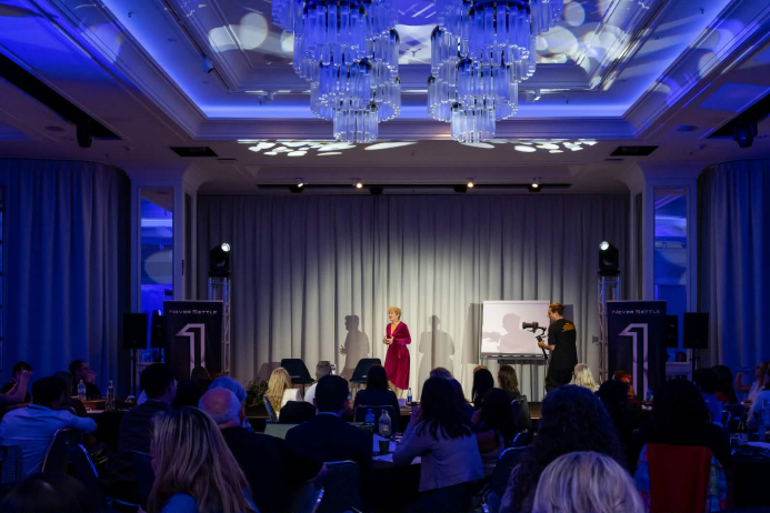 Julie Vigor delivering keynote presentation to corporate audience